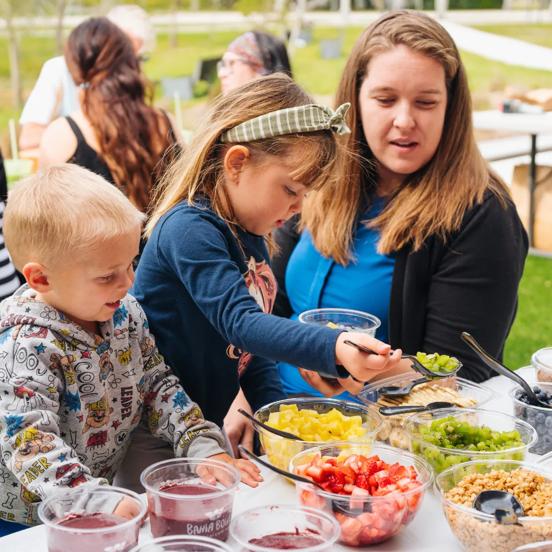 Kids creating custom acai bowls with fresh fruit toppings, a fun and healthy food option for children
